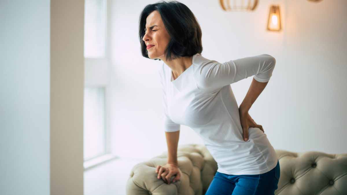 What causes pain at the bottom of your back?
