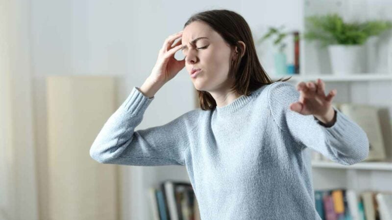 Dizziness - woman suffering vertigo attack at home