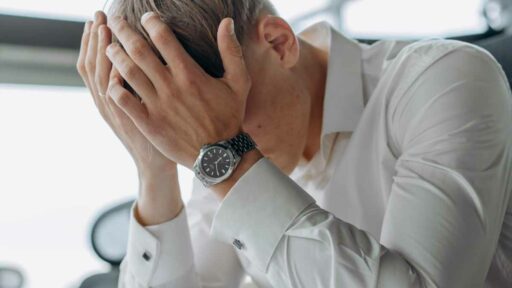 Fatigue - A Man Places His Hands on His Head