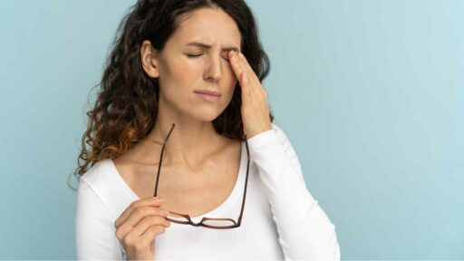 Fatigue - Woman Holding Glasses Rubbing Eye