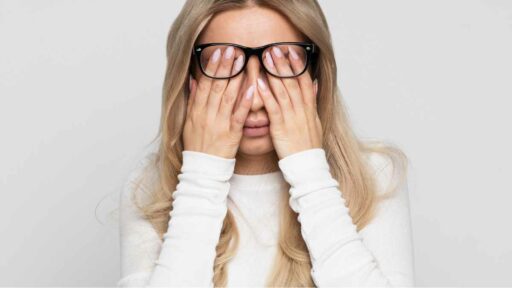 Fatigue - Woman in Eyeglasses Rubbing