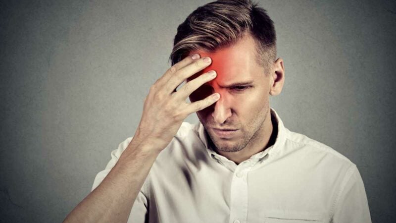 Headache - man with a painful migraine