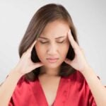 Headache - woman suffering a painful migraine