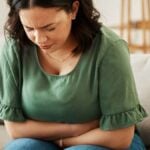 Lady with Tummy Ache in Living Room from Ibs