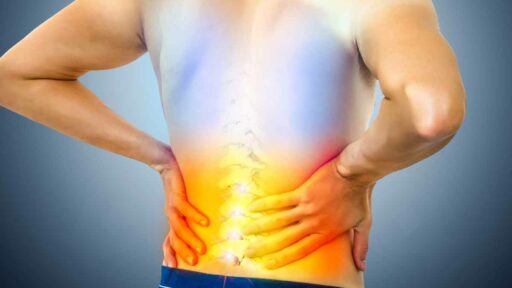 Lower Back Pain. Man Holding His Back in Pain