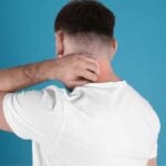 Nickel allergy - man scratching his neck