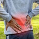 Sport man suffering from lower back pain