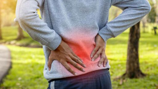 Sport man suffering from lower back pain