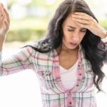 This young woman suddenly feels dizziness. Disoriented woman suffering from vertigo
