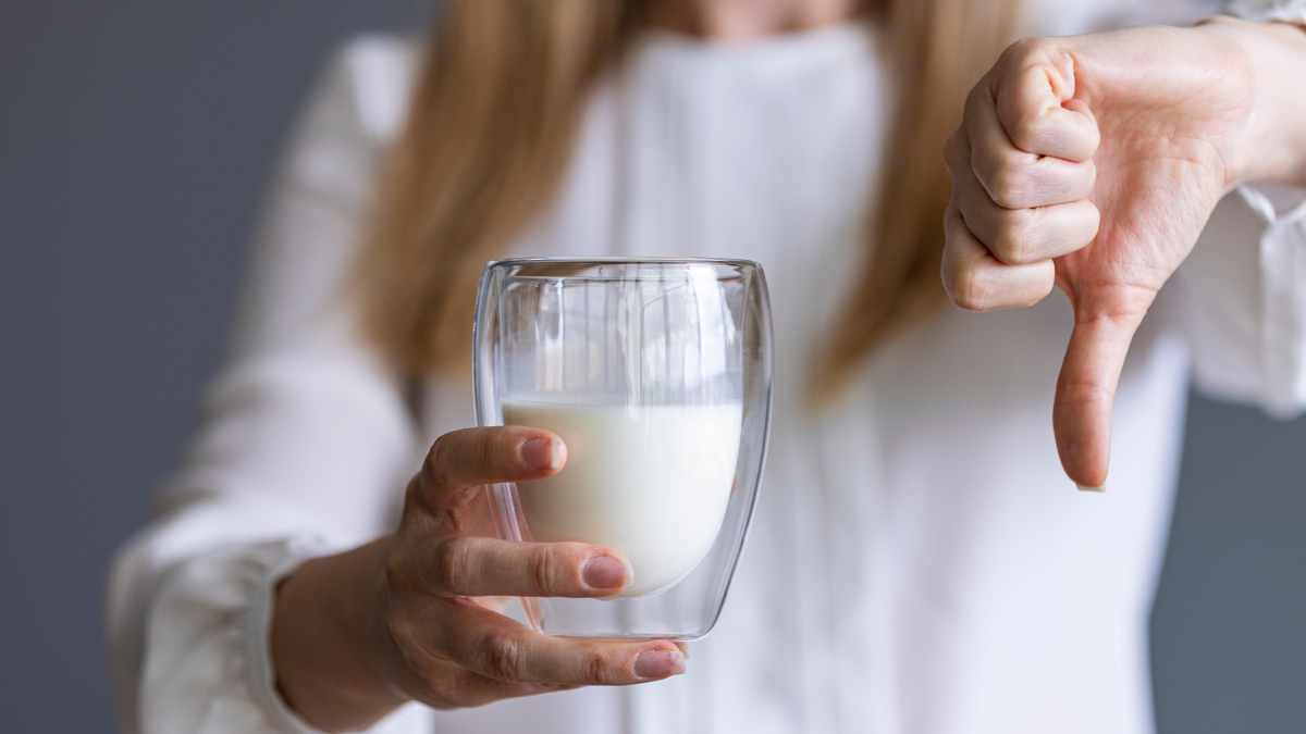 Woman with Lactose intolerance thumbs down