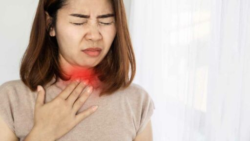 woman suffering from sore throat, heartburn