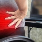 woman worker suffering from lower back pain from sitting too long