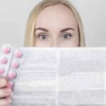 Ragazza che legge bugiardino del farmaco per prevenire effetti collaterali